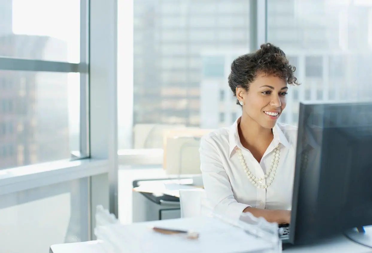 A woman sitting at her desk with a computer.